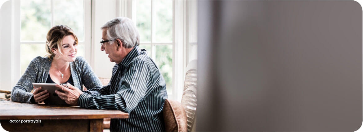 Woman & man chatting using iPad reflects taking advantage of Acadia Connect™ educational resources online