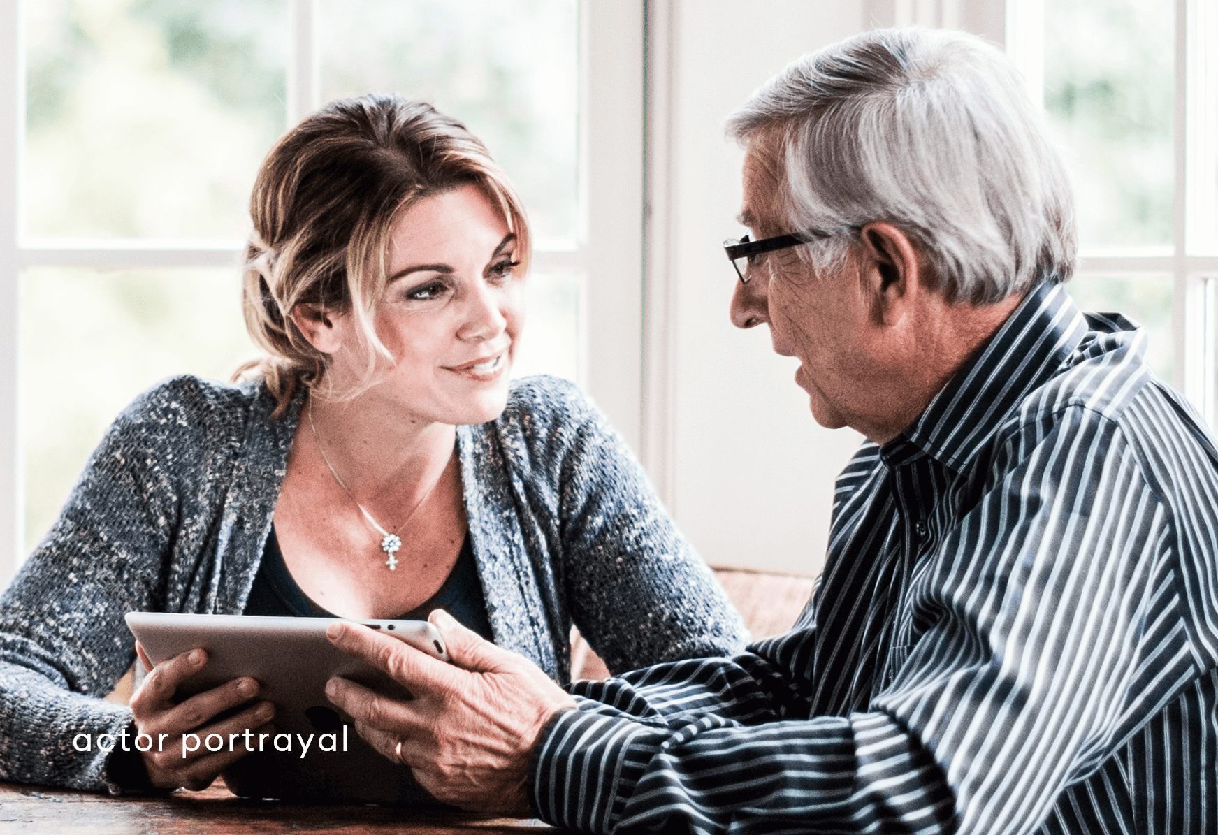 Woman & man chatting using iPad reflects taking advantage of Acadia Connect™ educational resources online